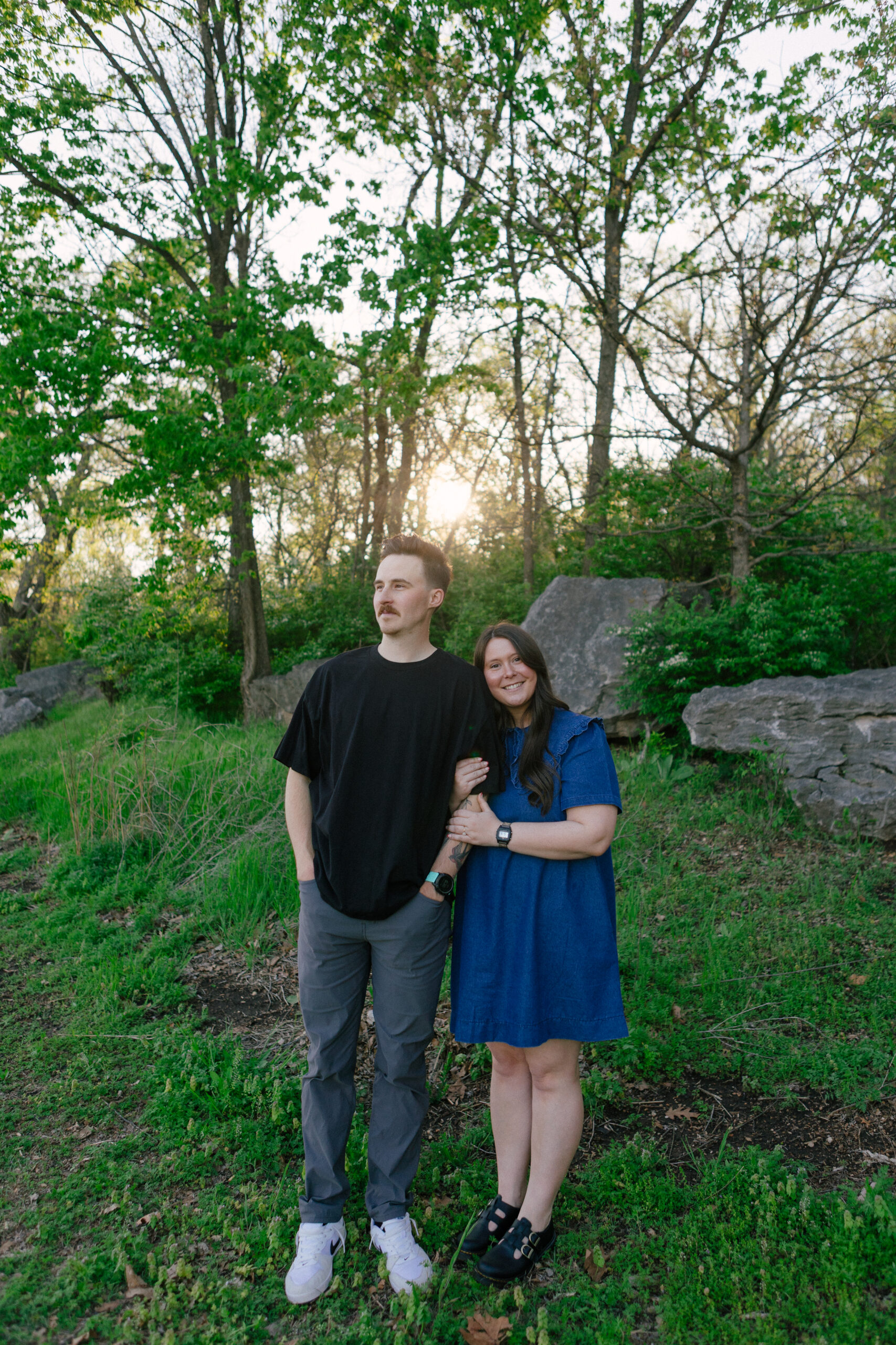 Edgy, non-traditional engaged couple embracing lakeside at sunset, photographed by Chelsea Stanford, alternative wedding photographer Missouri